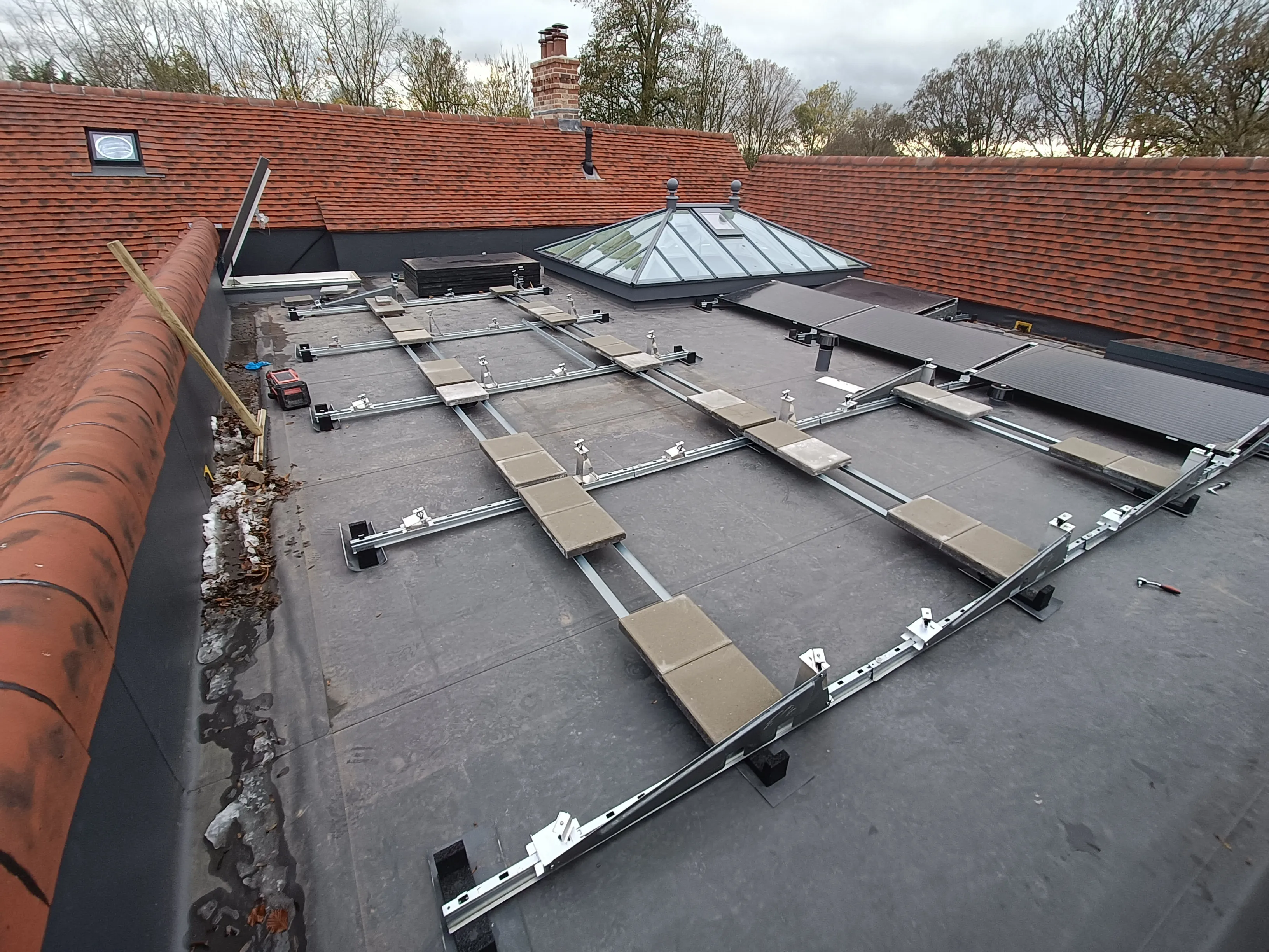 Ballasted flat roof solar mounting layout during reinstallation near Alton