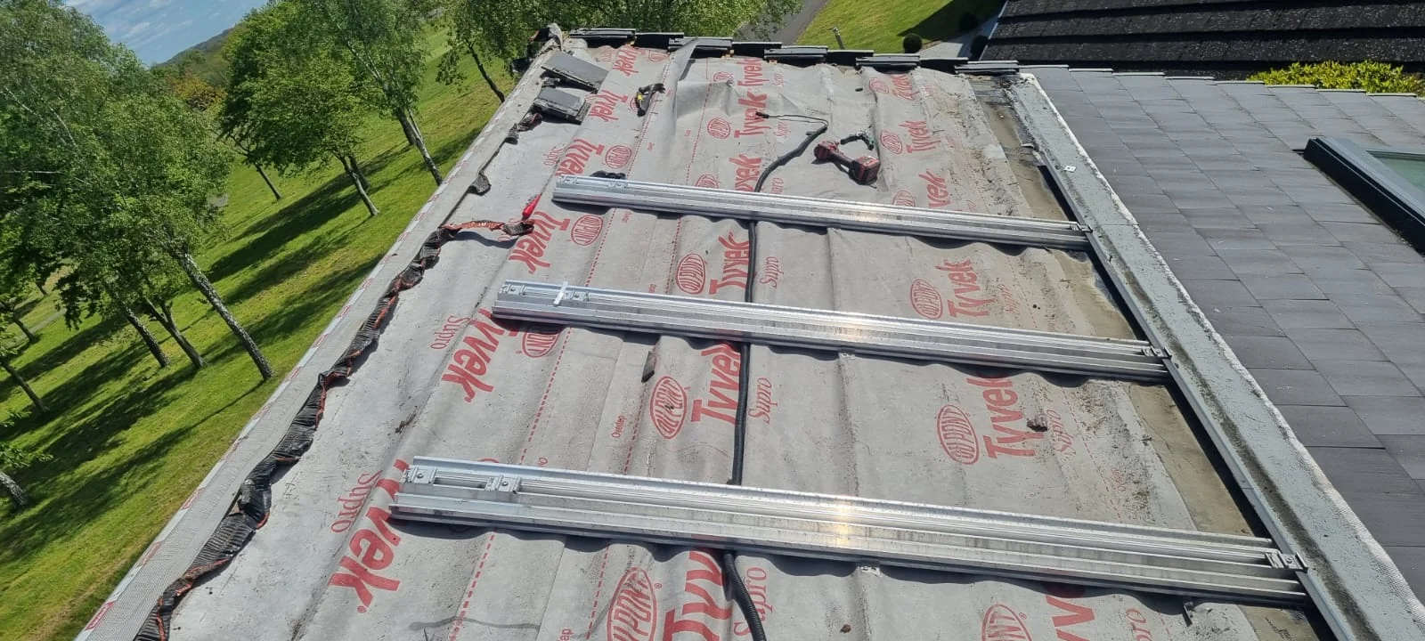 Existing in-roof solar PV mounting system partially removed during roof repair works