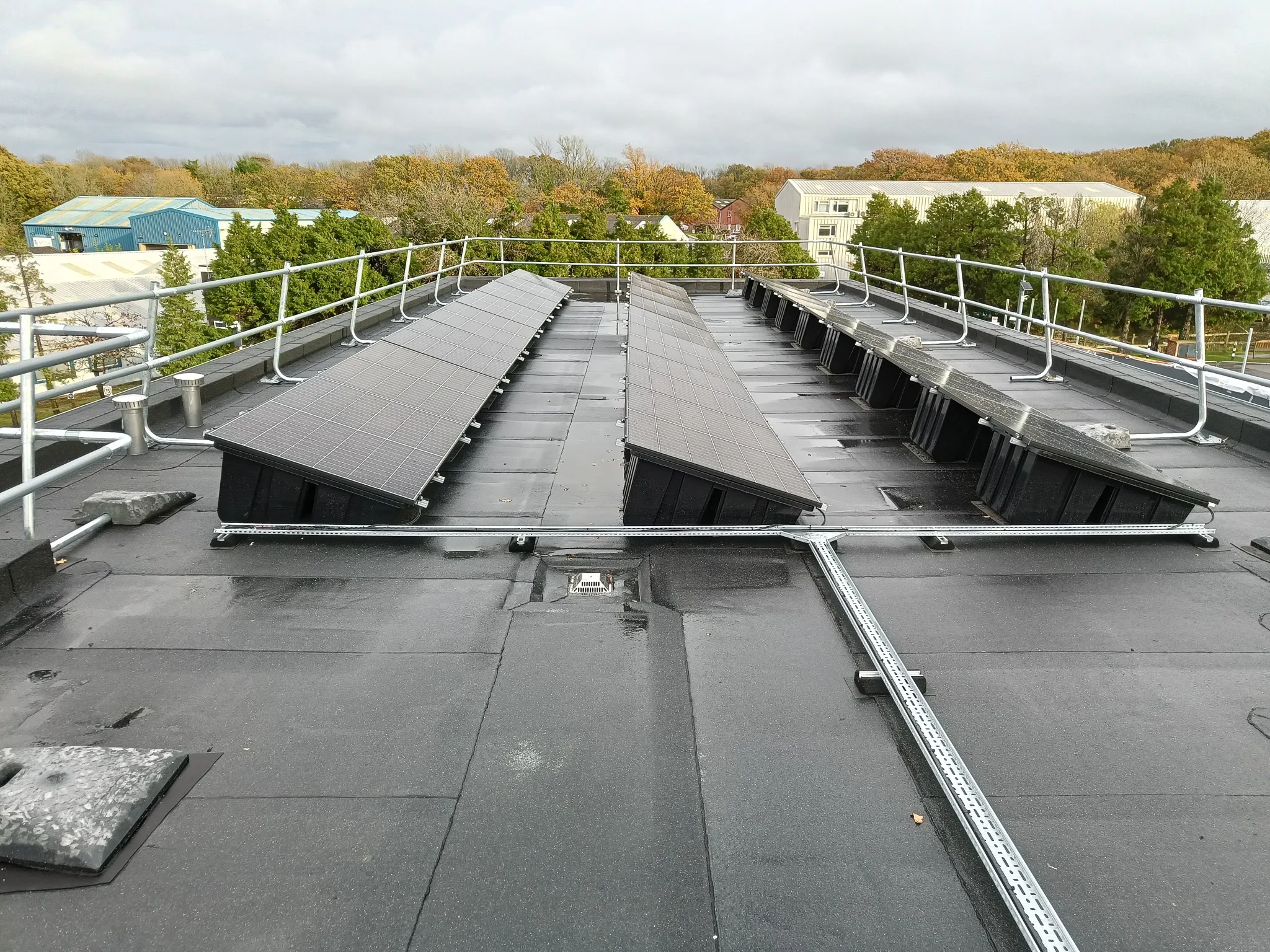 Installed commercial solar array on a flat roof in Small Dole using a non-penetrating mounting system